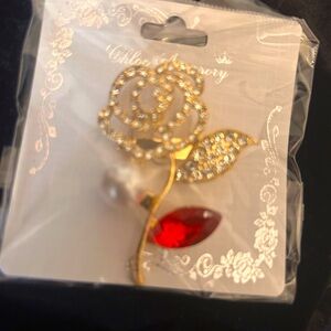 Elegant gold tone rhinestone Rose with a red pedal